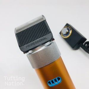May include: A gold electric hair clipper with a silver trim and a black blade. The blade has the word "PROFESSIONAL" printed on it.