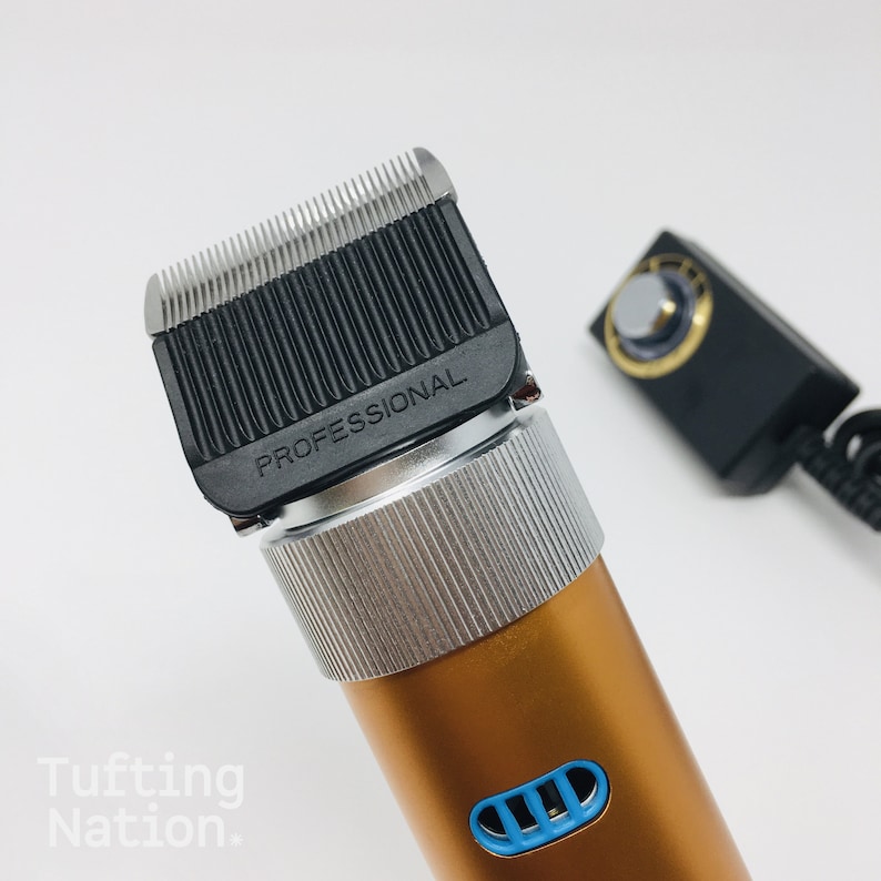 May include: A gold electric hair clipper with a silver trim and a black blade. The blade has the word "PROFESSIONAL" printed on it.