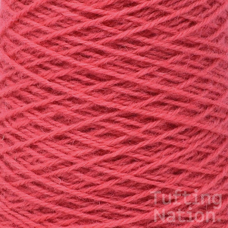 May include: A close-up of a spool of bright red yarn. The yarn is tightly wound and has a soft, fuzzy texture.