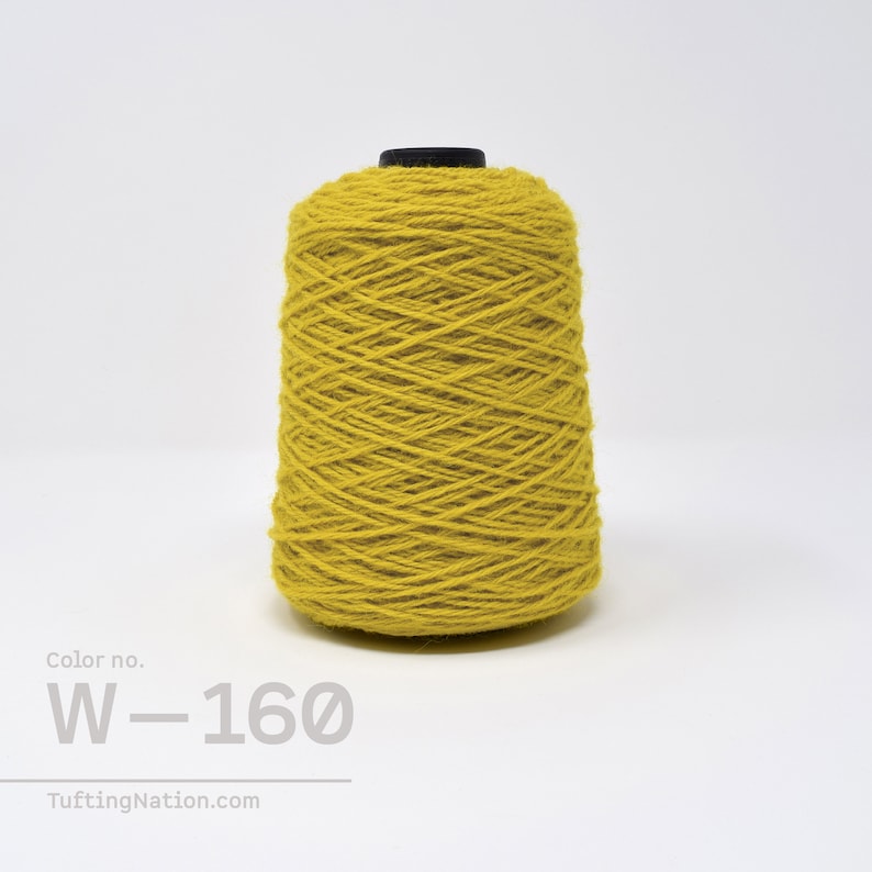May include: A spool of yellow wool yarn with the color number W-160. The yarn is wound tightly and has a smooth texture.