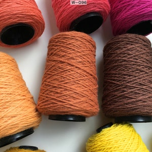 May include: Six spools of yarn in various shades of orange, brown, and yellow. The spools are labeled with the code "W-096".