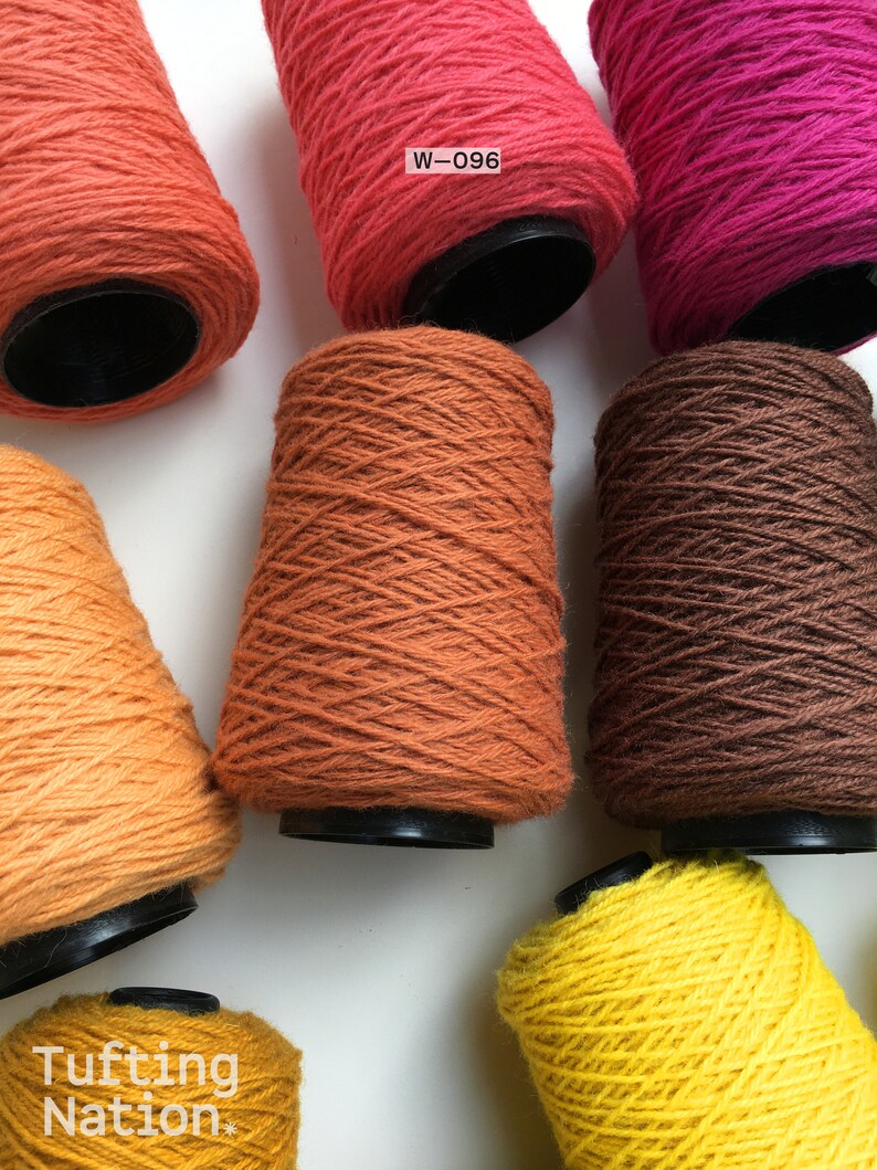 May include: Six spools of yarn in various shades of orange, brown, and yellow. The spools are labeled with the code "W-096".