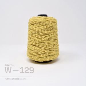May include: A spool of yellow yarn with the color number W-129. The yarn is wound tightly and is ready for use in crafting projects.