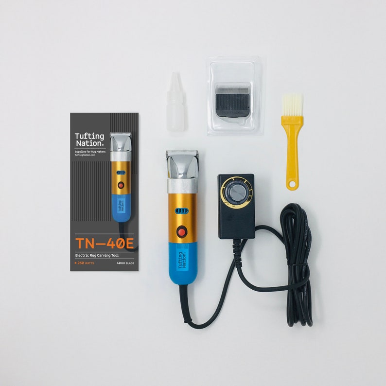 May include: A blue and gold electric rug carving tool with a power cord, a brush, a blade, and a bottle of oil. The tool is labeled "TN-40E Electric Rug Carving Tool".