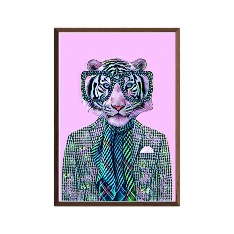 May include: A framed art print featuring a stylized tiger wearing large, square-framed glasses. The tiger is dressed in a patterned blazer, a striped scarf, and a pocket square, set against a pink background. The artwork has a whimsical and fashionable theme.