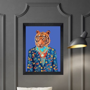 May include: Framed art print of a tiger in a floral suit, glasses, and jewellery against a blue backdrop. The tiger has orange and black fur, and the navy suit is adorned with colourful flowers. A unique piece of wall art.