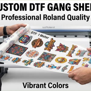 May include: A sheet of custom DTF gang stickers with vibrant colors is held up in front of a Roland printer. The sheet is labeled "DTF 1 Meter" and features various colorful sticker designs, including logos and illustrations.