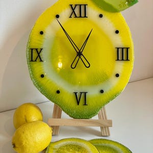 Lemon resin wall clock with black clock face and lemon coasters