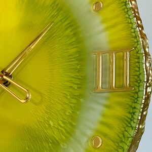 Lemon resin wall clock in details: the edges are painted with gold liquid