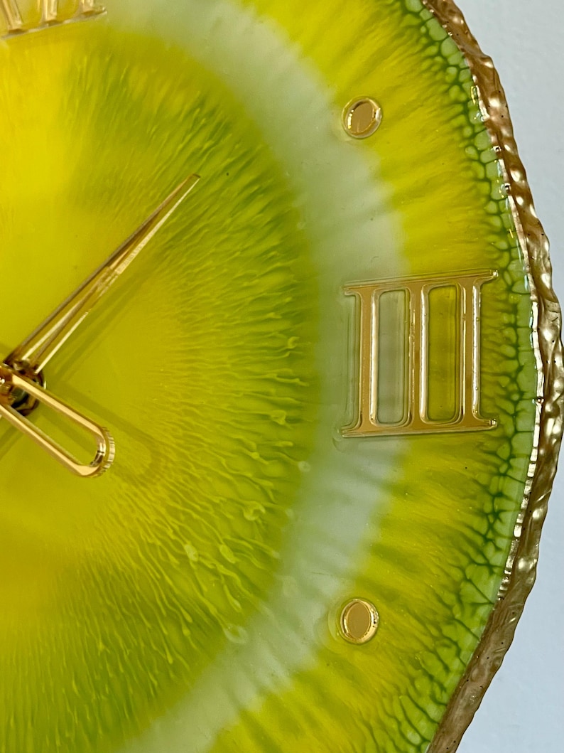 Lemon resin wall clock in details: the edges are painted with gold liquid