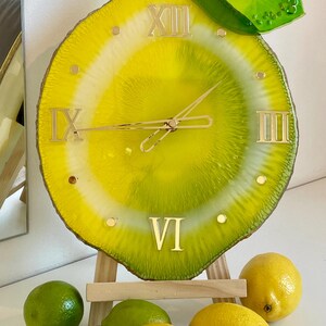 This lemon wall clock is not just a timekeeper; it is a piece of art that enlivens your space with its playful design and vibrant colors.