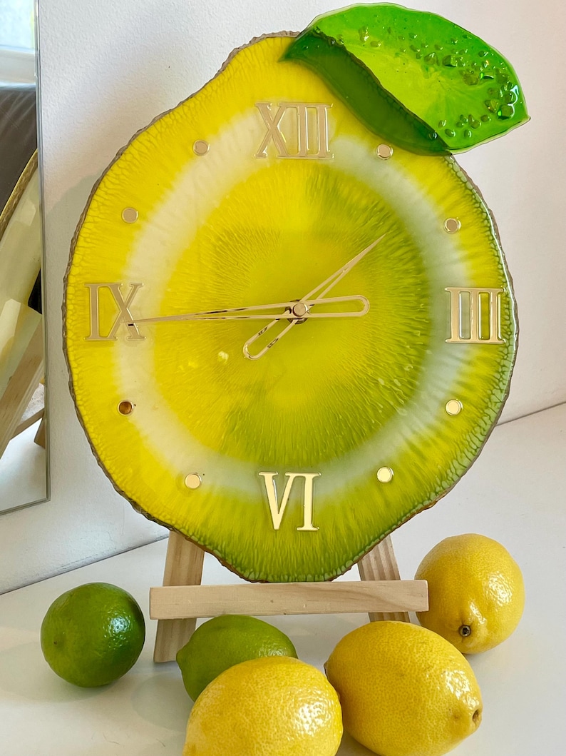 This lemon wall clock is not just a timekeeper; it is a piece of art that enlivens your space with its playful design and vibrant colors.