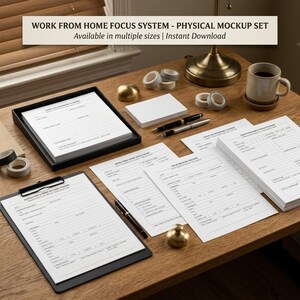 May include: A work from home focus system physical mockup set featuring white printed planner sheets, a black clipboard, two pens, a ceramic mug, rolls of washi tape, and a brass paperweight arranged on a wooden desk surface.