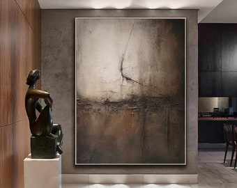 May include: Abstract painting in shades of brown, grey, and white with a textured surface. The painting is hanging on a wall in a modern interior.