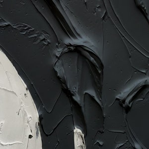 May include: Abstract painting featuring black and white paint. The black paint is thick and textured, while the white paint is smooth. The painting is abstract and modern.