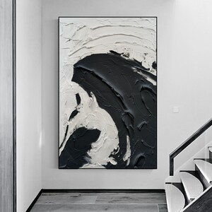 May include: Abstract painting with black and white paint strokes. The painting features a large, swirling black shape on a white background.