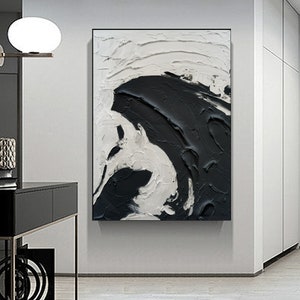 May include: Abstract painting with black and white paint strokes. The painting features a large black shape that appears to be a wave or a cloud.