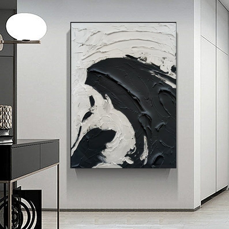 May include: Abstract painting with black and white paint strokes. The painting features a large black shape that appears to be a wave or a cloud.