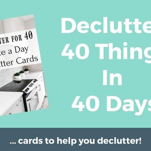 May include: A white and gray kitchen counter with a black stovetop and a set of cards that say "Declutter for 40 Once a Day Declutter Cards". The text "Declutter 40 Things In 40 Days" is written in white on a teal background. The text "...cards to help you declutter!" is written in white on a dark gray background.