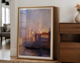 May include: A framed art print of a Venetian canal scene. The artwork features gondolas on the water, buildings, and a soft color palette of blues, purples, and golds. The frame is a light wood color.