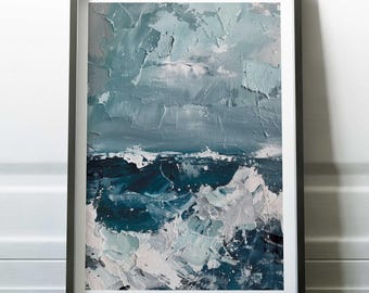 May include: Abstract ocean waves painting in a black frame. The artwork features textured brushstrokes in shades of blue, teal, and white, depicting a stormy sea. The painting is displayed against a white wall and dark wood floor.