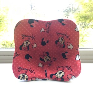 May include: Red fabric bowl with a polka dot pattern and Minnie Mouse images. The bowl has the text "with Minnie" and "Minnie" repeated on the fabric.