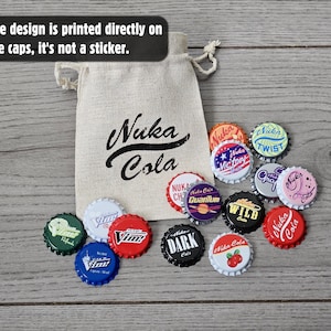 May include: A beige drawstring pouch with the black text Nuka Cola printed on the front, accompanied by a collection of colorful metal bottle caps featuring various graphic designs and logos. The design is printed directly on the caps, it's not a sticker.