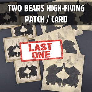 May include: A collection of square patches and cards featuring a black inkblot-style graphic of two bears high-fiving. The text "TWO BEARS HIGH-FIVING PATCH / CARD" appears at the top, and a red rectangular stamp reading "LAST ONE" is centered.