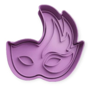 May include: Purple plastic cookie cutter shaped like a masquerade mask with a feathered design.