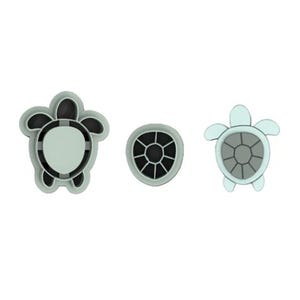May include: Three sea turtle-themed cookie cutters. The cutters are in the shape of a turtle, a turtle shell, and a turtle with a light blue body and a gray shell. The cutters are made of a light gray material.