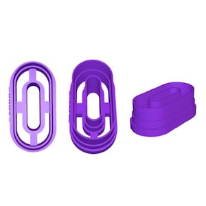 May include: Three purple oval-shaped cookie cutters. Two cutters are upright, showing the front and side profiles. The third cutter is lying on its side, displaying the layered design. The cutters have a hollow center.