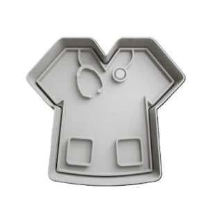 May include: A gray plastic cookie cutter shaped like a doctor's scrubs with a stethoscope.