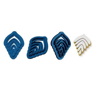 May include: Set of four blue cookie cutters shaped like seashells. The cutters are layered to create a 3D effect.