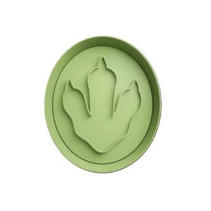 May include: Green plastic dinosaur footprint cookie cutter.
