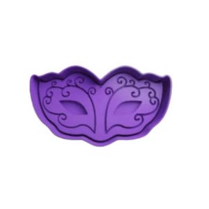 May include: Purple plastic cookie cutter shaped like a masquerade mask with intricate details.