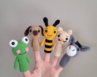 May include: Five finger puppets, including a frog, a dog, a bee, a cat, and a donkey. The puppets are made of crocheted yarn in various colors.