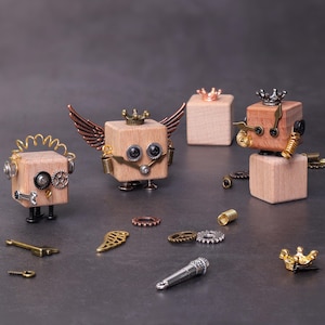 May include: Wooden block robots with steampunk-inspired details. Each robot has a crown, gears, and metal accents. One robot has wings, and another has a microphone. Various metal embellishments are scattered around the robots.