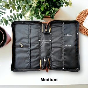 May include: Open brown leather Bible case with black lining. The case measures 11 inches long, 6.5 inches wide, and 2.5 inches deep. Medium.