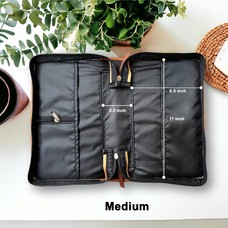 May include: Open brown leather Bible case with black lining. The case measures 11 inches long, 6.5 inches wide, and 2.5 inches deep. Medium.