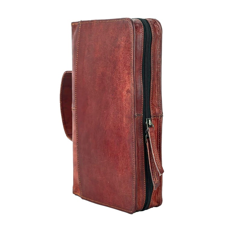 May include: A brown leather zippered portfolio with a handle.