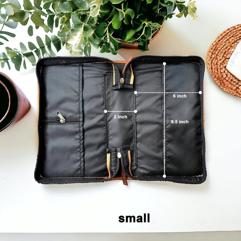 May include: Open brown leather zippered case with black fabric interior. The case has multiple compartments and measures 9.5 inches by 6 inches and 2 inches wide. The word "small" is printed below the case.