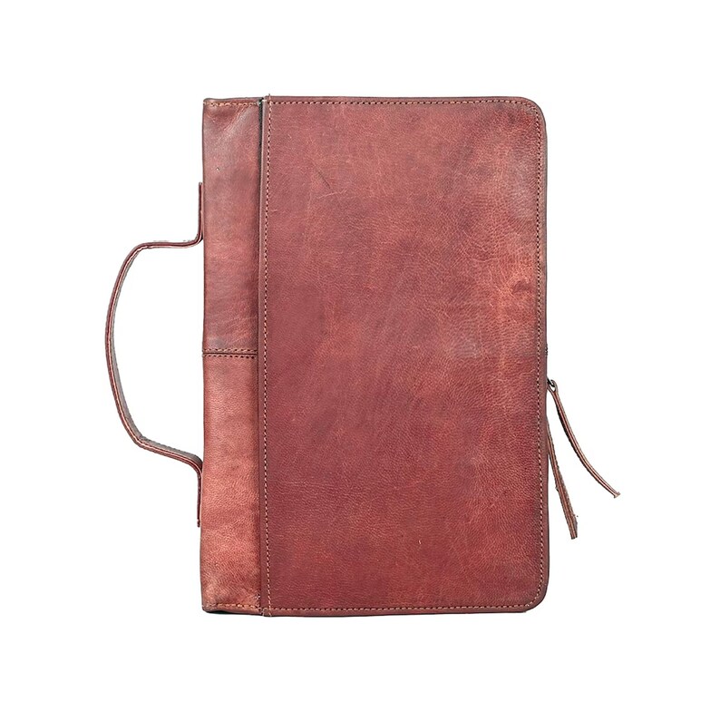 May include: A brown leather portfolio with a zipper closure and a handle.