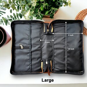 May include: Open brown leather Bible case with black lining and zippered pockets. The case measures 12 inches long, 8 inches wide, and 3 inches deep.  Large.