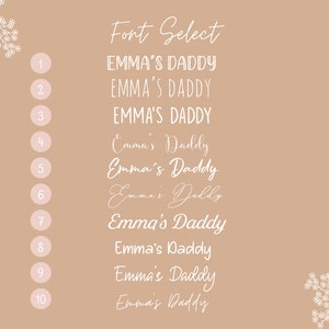 May include: A beige background with a white floral design on either side.  The text "Font Select" is at the top of the image.  The numbers 1 through 10 are listed on the left side of the image.  Next to each number is a different font style of the text "Emma's Daddy".