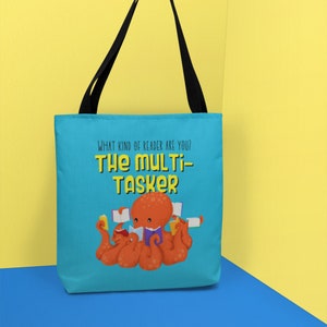May include: A blue tote bag with a cartoon octopus reading multiple books. The text on the bag reads "What kind of reader are you? The Multi-Tasker".