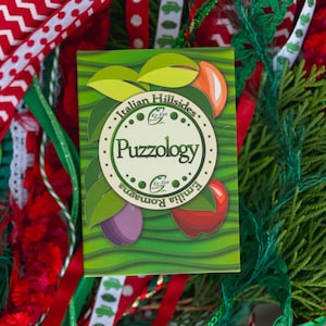 May include: A green card with the words "Italian Hillsides" and "Puzzology" in a circle. The card has a red and white design with the words "Famiglia Romana" and "Ko-Kee Sweets" on it.