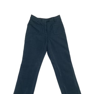 May include: Dark blue high-waisted pants with large patch pockets on the front.