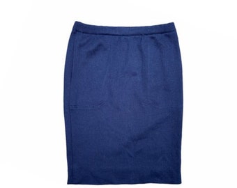 May include: A dark blue knitted skirt with a single pocket on the front.