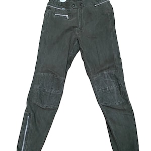 May include: Dark green cargo pants with zippered pockets and knee pads.