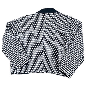 May include: A black and white patterned blazer with a black collar. The blazer has a cropped length and long sleeves.